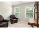 Cozy bedroom featuring two armchairs, neutral walls, and plenty of natural light from the window at 374 Heritage, Woodstock, GA 30188