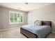 Cozy bedroom with a comfortable bed, neutral tones, and a large window at 374 Heritage, Woodstock, GA 30188