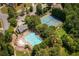 Aerial shot featuring a community pool and tennis courts surrounded by lush trees at 374 Heritage, Woodstock, GA 30188