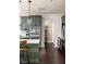 A kitchen featuring dark green cabinets, stainless steel appliances, and an arched doorway at 374 Heritage, Woodstock, GA 30188