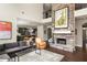 Living room with a stone fireplace, hardwood floors, comfortable seating, and open access to the kitchen at 374 Heritage, Woodstock, GA 30188