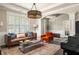 Cozy living room featuring hardwood floors, a decorative chandelier, and a comfortable seating arrangement with stylish accents at 374 Heritage, Woodstock, GA 30188
