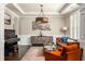 Elegant living room featuring hardwood floors, a stylish chandelier, and comfortable seating arrangements with chic accents at 374 Heritage, Woodstock, GA 30188