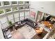 Open living space features many windows, hardwood floors, and flows into kitchen and dining area at 374 Heritage, Woodstock, GA 30188