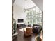 Bright living room boasts a soaring wall of windows, high ceilings, hardwood floors, and an open floor plan at 374 Heritage, Woodstock, GA 30188
