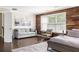 Stylish main bedroom with wood accent wall, comfortable seating area, and ample natural light at 374 Heritage, Woodstock, GA 30188