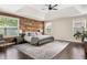 Inviting main bedroom featuring a wood accent wall, plush rug, and plenty of natural light at 374 Heritage, Woodstock, GA 30188