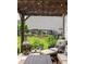 Cozy outdoor patio area with comfortable seating, a fire pit, and views of the landscaped backyard at 374 Heritage, Woodstock, GA 30188