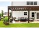Relaxing outdoor patio with pergola, comfortable seating, and a well-maintained lawn at 374 Heritage, Woodstock, GA 30188