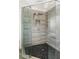 Luxurious shower with gray tiled walls, a rainfall showerhead, and a pebbled floor at 374 Heritage, Woodstock, GA 30188