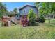 Exterior of the home's backyard with a playset, lawn, deck and trees at 4345 Tucker North Dr, Tucker, GA 30084