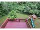 View of a painted back deck and playset overlooking a lush green backyard forest at 4345 Tucker North Dr, Tucker, GA 30084