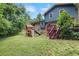 Exterior of the home's backyard with a playset, lawn and deck at 4345 Tucker North Dr, Tucker, GA 30084