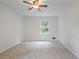 A bright, carpeted bedroom features a ceiling fan and window at 4345 Tucker North Dr, Tucker, GA 30084