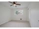 A bright, carpeted bedroom features a ceiling fan, window, and closet at 4345 Tucker North Dr, Tucker, GA 30084