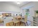 Bright dining area features an adjacent view into the living room and a sunlit window with backyard view at 4345 Tucker North Dr, Tucker, GA 30084