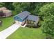 Aerial of a charming home with a well-manicured lawn, a two-car garage, and mature landscaping at 4345 Tucker North Dr, Tucker, GA 30084