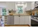 Updated kitchen features stone countertops, stainless steel appliances, and white cabinets at 4345 Tucker North Dr, Tucker, GA 30084