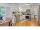 Modern kitchen with white cabinets, stainless steel appliances, and open dining area at 4345 Tucker North Dr, Tucker, GA 30084