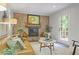 Inviting living room with brick fireplace and door to the back deck at 4345 Tucker North Dr, Tucker, GA 30084