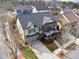 Aerial view of a well-maintained two-story home with a front-facing garage and a landscaped yard at 4492 Arbor Crest Ct, Suwanee, GA 30024
