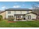 Backyard of the home features a patio with outdoor seating and mature landscaping at 4492 Arbor Crest Ct, Suwanee, GA 30024