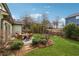 Well-maintained backyard featuring a stone patio with seating and manicured lawn at 4492 Arbor Crest Ct, Suwanee, GA 30024