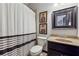 Cozy bathroom features a stylish black and white shower curtain, framed art and neutral-toned vanity at 4492 Arbor Crest Ct, Suwanee, GA 30024