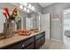 This bathroom features a large mirror, vanity, and fixtures, creating a functional and convenient atmosphere at 4492 Arbor Crest Ct, Suwanee, GA 30024
