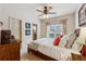 Cozy bedroom featuring a queen-size bed, wood floors, and natural light at 4492 Arbor Crest Ct, Suwanee, GA 30024