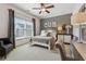This bedroom features a window, neutral carpeting, and ceiling fan creating a relaxing and comfortable atmosphere at 4492 Arbor Crest Ct, Suwanee, GA 30024