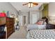 This bedroom features two twin beds, ceiling fan, neutral carpeting, and stylish decor, creating a charming and inviting space at 4492 Arbor Crest Ct, Suwanee, GA 30024