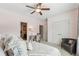 This bedroom features neutral carpeting, and ceiling fan creating a relaxing and comfortable atmosphere at 4492 Arbor Crest Ct, Suwanee, GA 30024