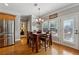 Cozy dining area adjacent to the kitchen with wood floors and bright natural light at 4492 Arbor Crest Ct, Suwanee, GA 30024