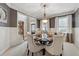 Charming dining room with wainscoting, neutral paint, and a round table for formal dining at 4492 Arbor Crest Ct, Suwanee, GA 30024