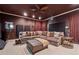 Comfortable home theater featuring a plush sectional, projector, and warm, inviting decor at 4492 Arbor Crest Ct, Suwanee, GA 30024