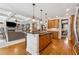 Open-concept kitchen featuring hardwood floors and connection to the living room at 4492 Arbor Crest Ct, Suwanee, GA 30024