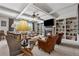 Cozy living room features coffered ceilings, fireplace, built-in bookshelves, and comfortable seating at 4492 Arbor Crest Ct, Suwanee, GA 30024