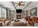 Comfortable living room features a fireplace, built-in shelving, and plush seating arrangement at 4492 Arbor Crest Ct, Suwanee, GA 30024