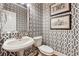 Stylish powder room with patterned wallpaper and a pedestal sink at 4492 Arbor Crest Ct, Suwanee, GA 30024