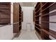 A walk-in closet with custom wood shelving, providing ample storage space at 4492 Arbor Crest Ct, Suwanee, GA 30024