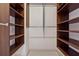 Spacious walk-in closet with wood shelving providing great storage solutions at 4492 Arbor Crest Ct, Suwanee, GA 30024