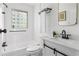 Bright bathroom featuring a tub/shower combo, stylish fixtures and a window providing natural light at 462 Kendrick Se Ave, Atlanta, GA 30315