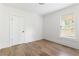 Neutral bedroom with hardwood floors, white walls, and a window letting in natural light at 462 Kendrick Se Ave, Atlanta, GA 30315