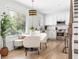 Bright eat-in kitchen featuring white cabinetry, stainless appliances, and hardwood floors at 462 Kendrick Se Ave, Atlanta, GA 30315