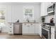 Modern kitchen with stainless steel appliances, white cabinets, and subway tile backsplash at 462 Kendrick Se Ave, Atlanta, GA 30315