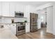 Bright kitchen with white cabinets, stainless appliances, and light wood floors at 462 Kendrick Se Ave, Atlanta, GA 30315