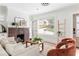 Cozy living room with a brick fireplace, hardwood floors, and natural light at 462 Kendrick Se Ave, Atlanta, GA 30315