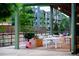 Outdoor dining with white tables, wooden planters, and a backdrop of greenery and apartment buildings at 462 Kendrick Se Ave, Atlanta, GA 30315
