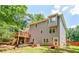 Back exterior view of home with large backyard and deck space at 5028 Jamie Ne Ct, Woodstock, GA 30188
